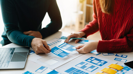 Fototapeta premium UX graphic designer planning application process development prototype wireframe for web smart phone. Creative digital development agency...