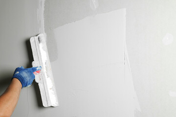 Professional worker plastering wall with putty knife, closeup - obrazy, fototapety, plakaty