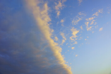 Half of the blue sky is completely clear and half is covered in clouds