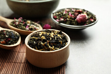 Different herbal teas on grey table, closeup