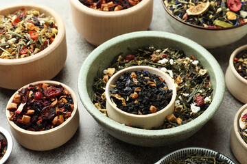 Many different herbal teas on grey table