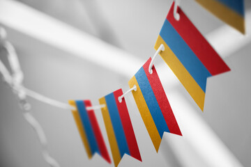 A garland of Armenia national flags on an abstract blurred background