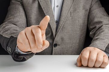 Businessman in a suit pointing with his finger