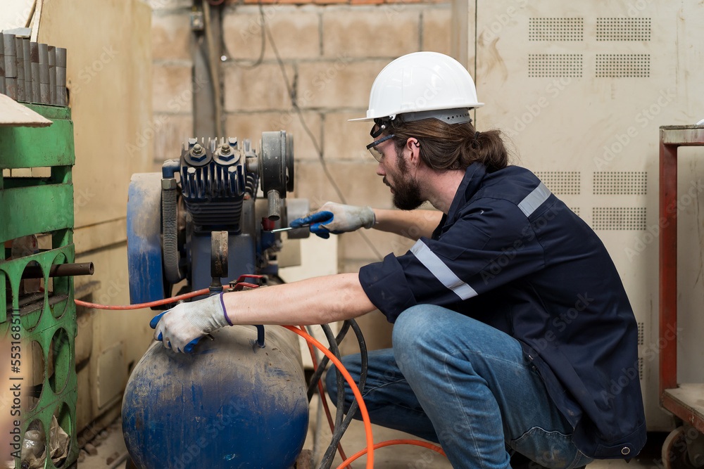 Poster male engineer worker using air compressor in the industry factory. male engineer worker checking or 