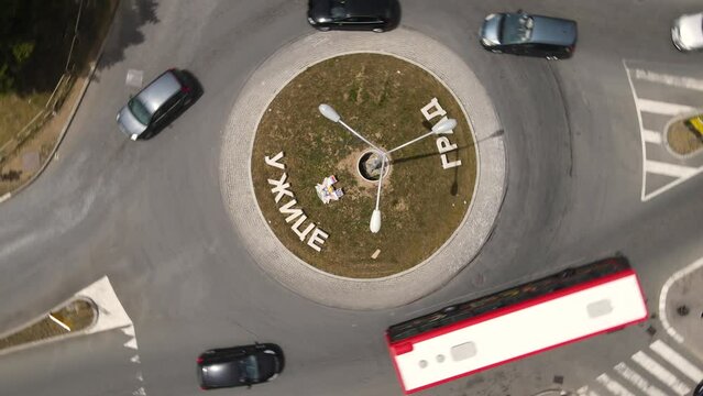 City of Uzice, Serbia. Top Down Aerial View of Roundabout Traffic, Spinning High Angle Drone Shot