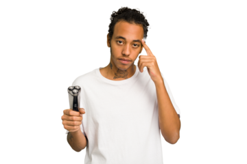 Young African American man holding a razor isolated pointing temple with finger, thinking, focused on a task.