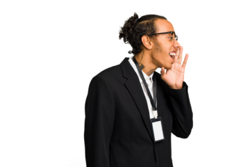 Young African American business man with badge isolated shouting and holding palm near opened mouth.