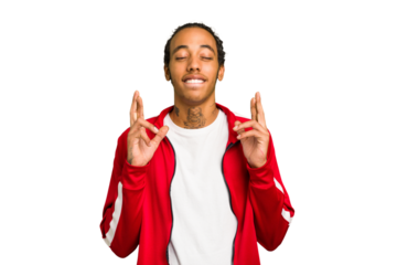 Young African American man isolated crossing fingers for having luck