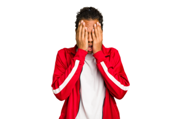 Young African American man isolated having fun covering half of face with palm.