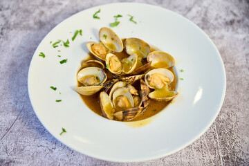 Clam stew plate on white marble table
