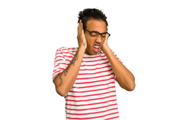 Young African American man isolated covering ears with hands trying not to hear too loud sound.