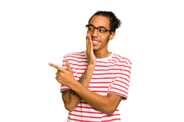 Young African American man isolated saying a gossip, pointing to side reporting something.