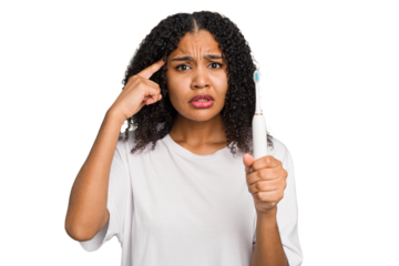 Young african american using a brushing teeth isolated showing a disappointment gesture with forefinger.