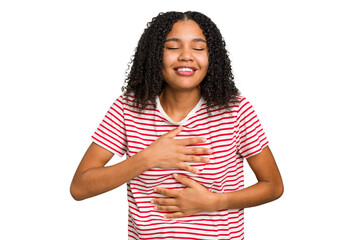 Young african american woman with curly hair cut out isolated laughs happily and has fun keeping hands on stomach.