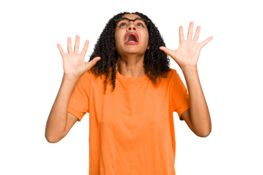 Young african american woman with curly hair cut out isolated screaming to the sky, looking up, frustrated.