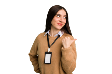 Young caucasian woman with ID card isolated points with thumb finger away, laughing and carefree.