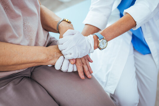 Cropped shot of an unrecognizable female nurse comforting a patient in the hospital. Health worker holding patient's hand. Cropped shot of a senior woman holding hands with a nurse