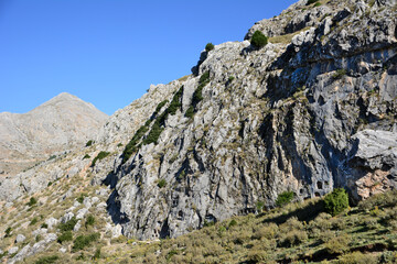 Fototapeta na wymiar rocky mountain isolated with blue sky on background, close-up