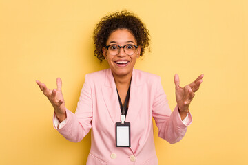 Young caucasian business brazilian woman with a badge isolated receiving a pleasant surprise,...