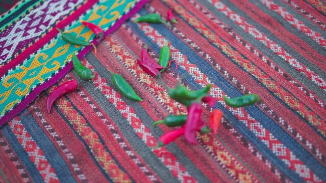 Hot peppers are thrown on a handmade carpet