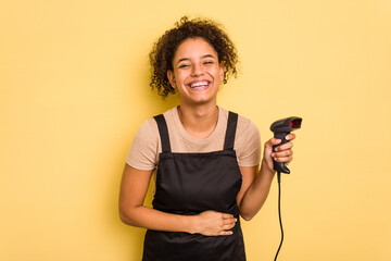 Young brazilian work woman holding a hand sticker price label machine isolatedYoung brazilian woman holdilaughing and having fun.