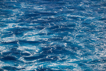 Blue sea background. Vessel ocean wake. Marine waves. Outdoor