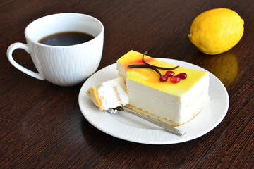 lemon cake with cup of coffee and lemon fruit, close-up