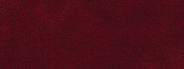 Texture of velvet matte dark red background, macro. Suede wine fabric with pattern. Textile leather backdrop,