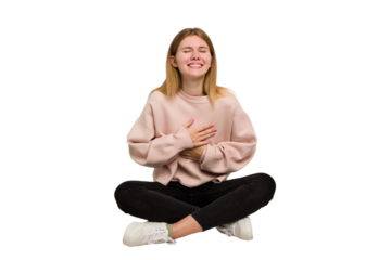 Young caucasian woman sitting on the floor cutout isolated