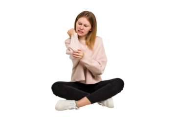 Young caucasian woman sitting on the floor cutout isolated