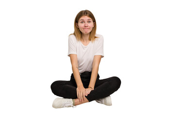 Young caucasian woman sitting on the floor cutout isolated