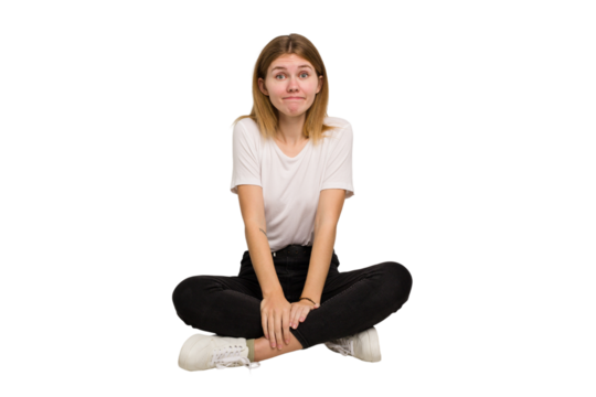 Young caucasian woman sitting on the floor cutout isolated