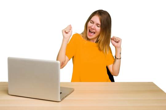Young caucasian woman in a workplace working with a laptop isolated dancing and having fun.