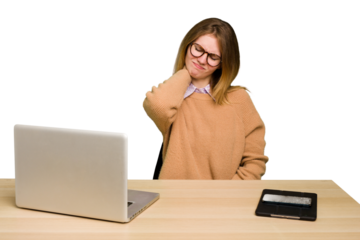 Young caucasian woman in a workplace working with a laptop isolated having a neck pain due to stress, massaging and touching it with hand.