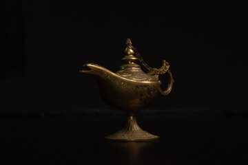 Aladdin's magic lamp isolated on black background