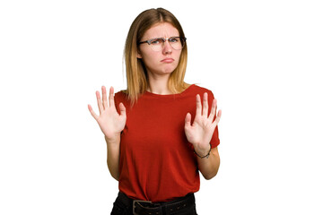 Young caucasian woman isolated rejecting someone showing a gesture of disgust.