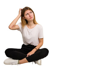 Fototapeta na wymiar Young caucasian woman sitting on the floor cutout isolated