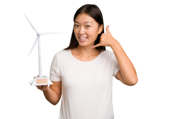 Young asian woman holding a small wind energy mill isolated showing a mobile phone call gesture with fingers.