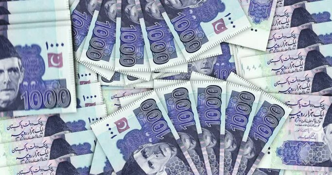 Pakistani rupee banknotes in a cash fan mosaic pattern loop. Pakistan 1000 PKR notes. Abstract concept of bank, finance, economy seamless and looped decorative design background.