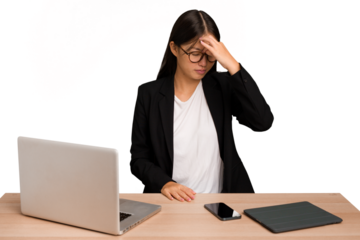 Young business asian woman sitting on a table isolated having a head ache, touching front of the face.