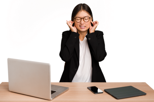 Young business asian woman sitting on a table isolated covering ears with hands. - Powered by Adobe