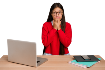 Young student asian woman in a workplace with a laptop isolated shocked, covering mouth with hands, anxious to discover something new.