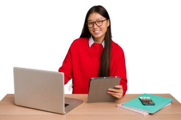Young student asian woman in a workplace with a laptop isolated