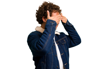Young curly smart caucasian man cut out isolated afraid covering eyes with hands.