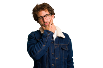 Young curly smart caucasian man cut out isolated contemplating, planning a strategy, thinking about the way of a business.