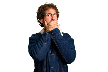 Young curly smart caucasian man cut out isolated thoughtful looking to a copy space covering mouth with hand.