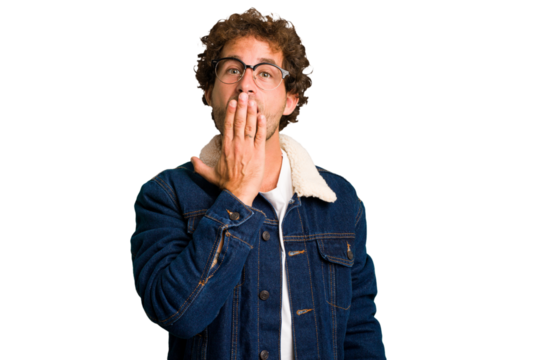Young curly smart caucasian man cut out isolated shocked, covering mouth with hands, anxious to discover something new.