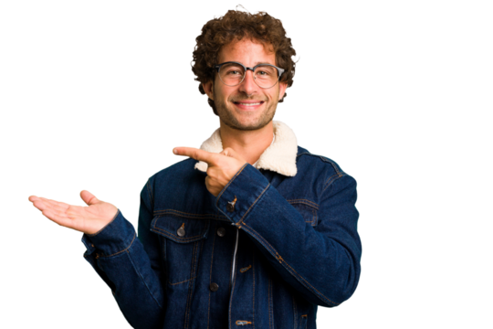 Young curly smart caucasian man cut out isolated excited holding a copy space on palm.
