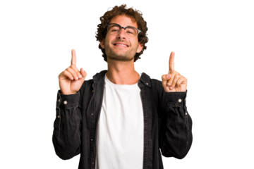 Young curly smart caucasian man cut out isolated indicates with both fore fingers up showing a blank space.