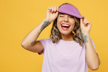 Calm young woman wear purple pyjamas jam rest relax at home take off sleep eye blindfold mask wink look camera smiling isolated on plain yellow background studio portrait. Good mood night nap concept